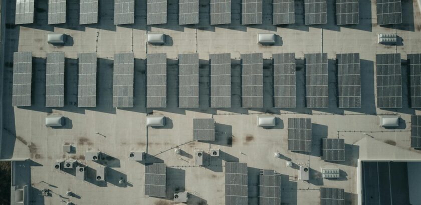 Discover the efficiency of solar energy with this aerial shot of solar panels on a rooftop.